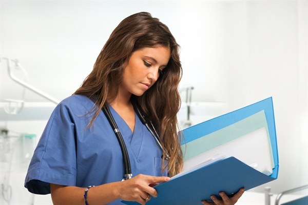 Female healthcare worker reviewing patient file